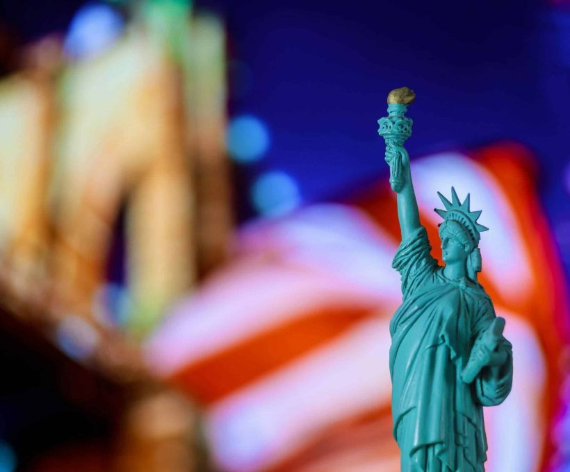 Statue of Liberty, United Stated flag background, Brooklyn Bridge New York, USA